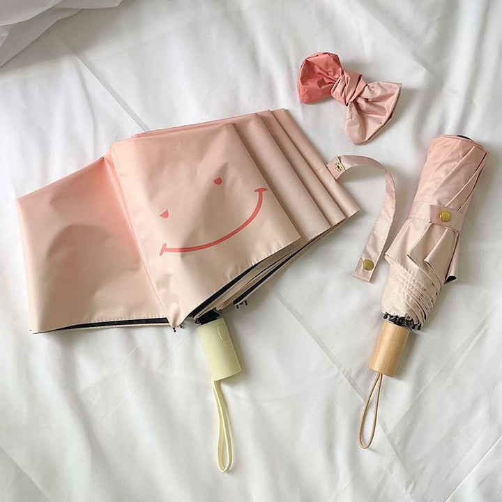 Women's foldable umbrella with playful design and handy wooden handle Bowlift