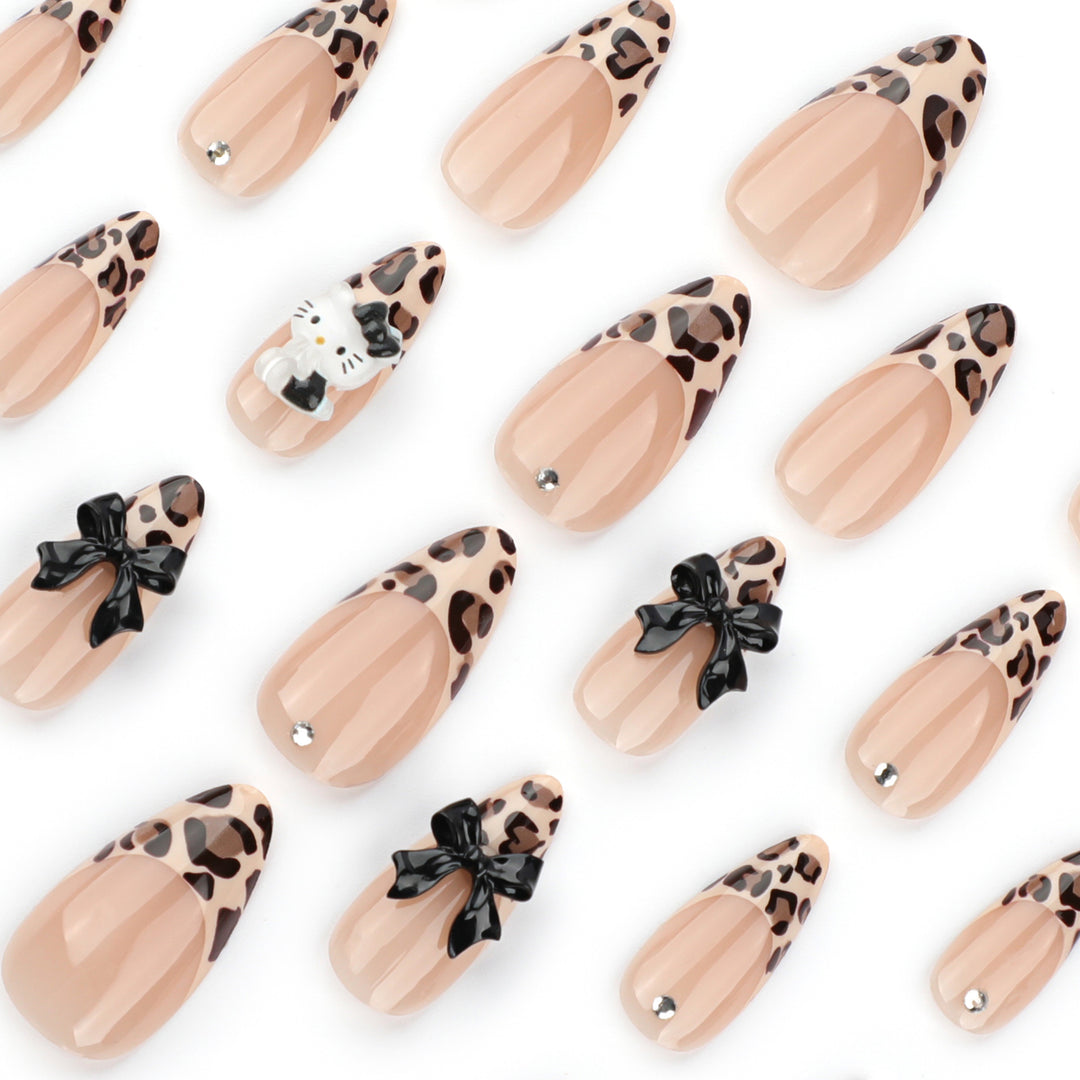 Artistic extension nails in leopard pattern with bow accents Bowlift