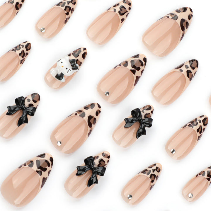 Artistic extension nails in leopard pattern with bow accents Bowlift