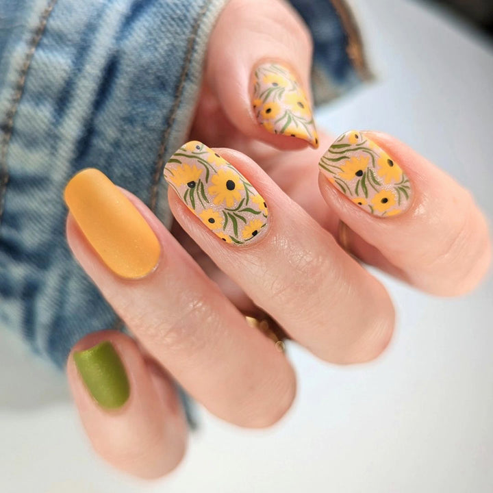 Artistic nail extensions with floral designs and creative color accents Bowlift