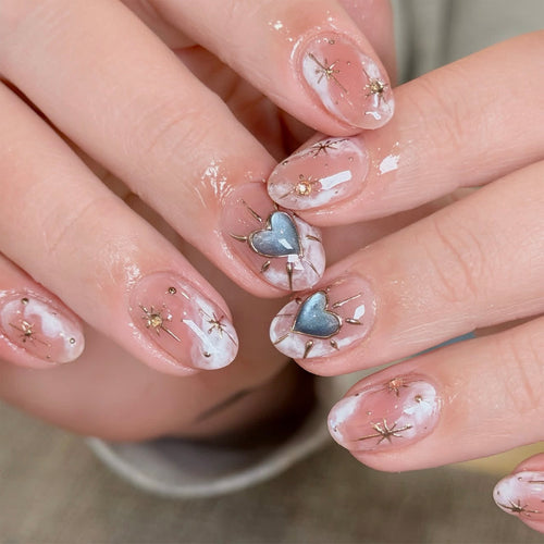 Nail design with decorative hearts and glitter accents Bowlift