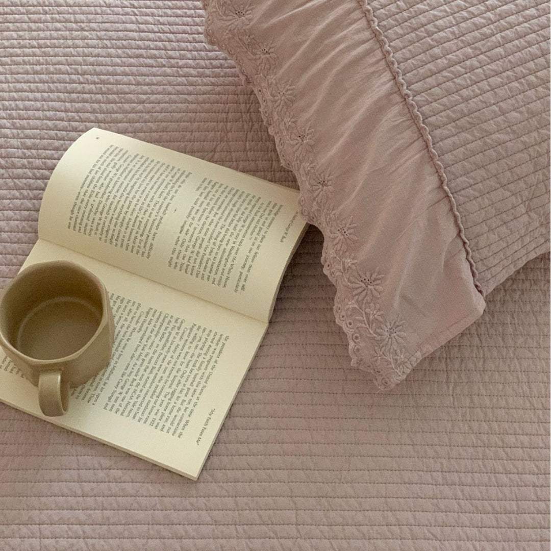 Quilted bedspread with ruffled trim and fine quilted texture
