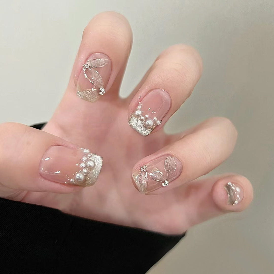 Elegant artificial nails with pearl decorations and glitter effects Bowlift