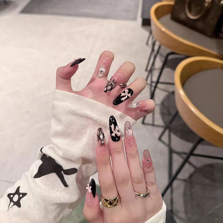 Artificial nails with playful bow design and glitter effects Bowlift