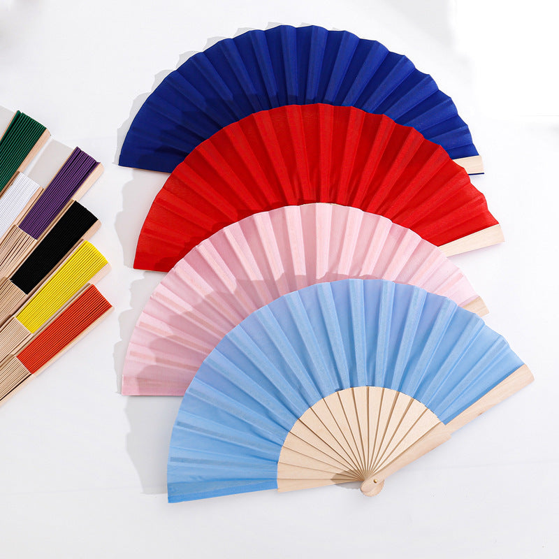 Ladies folding hand fan made of airy material with intricate folds Bowlift