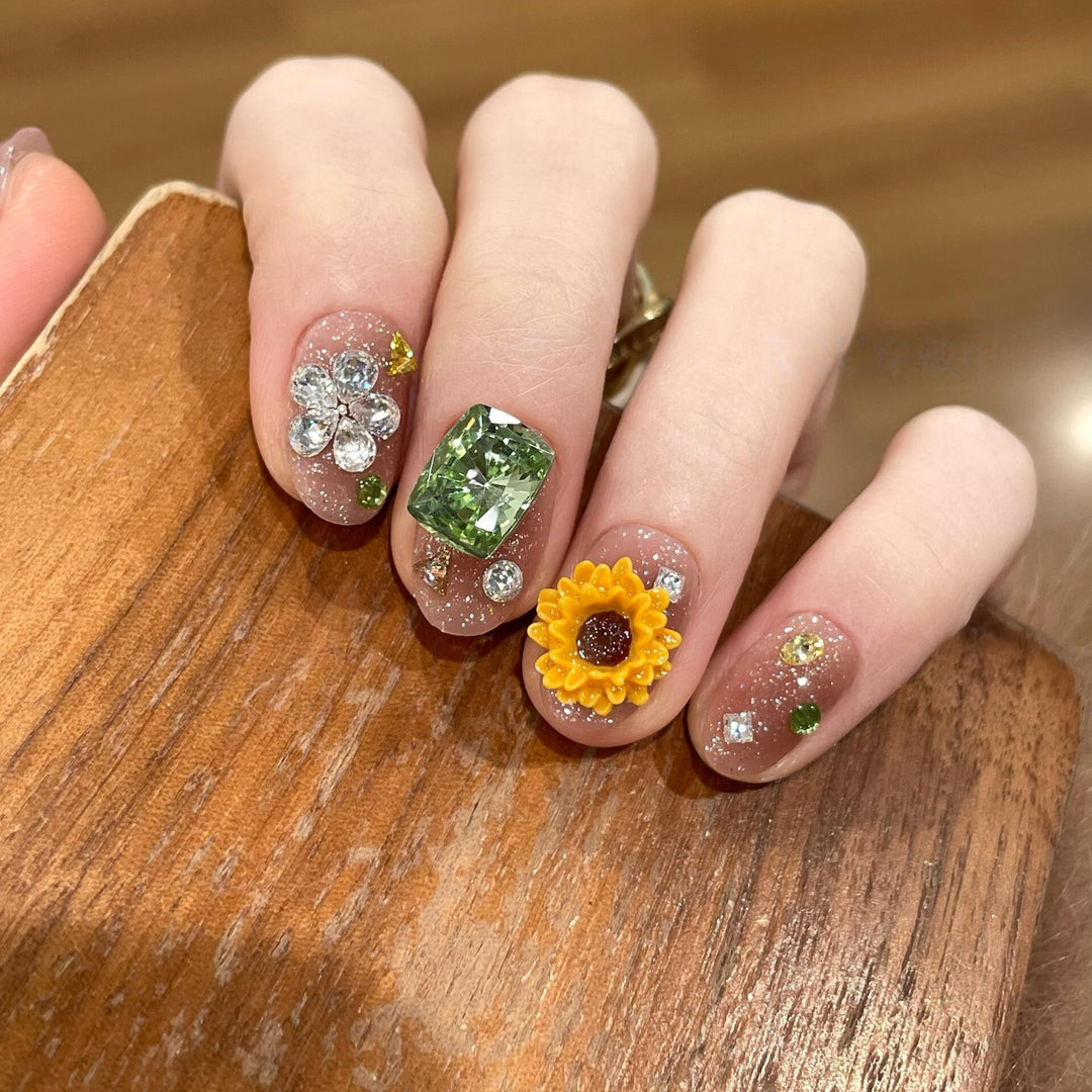 Artificial nails with sparkling appliqués and floral designs Bowlift