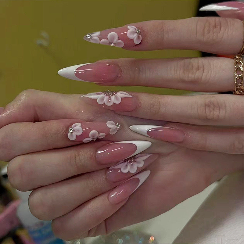 Elegant artificial nail set with floral design and glitter accents Bowlift