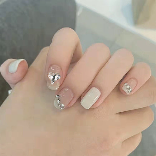 Glamorous artificial nails with heart and rhinestone decorations Bowlift