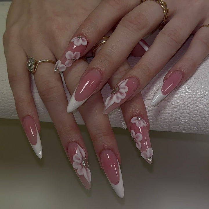 Elegant artificial nail set with floral design and glitter accents Bowlift