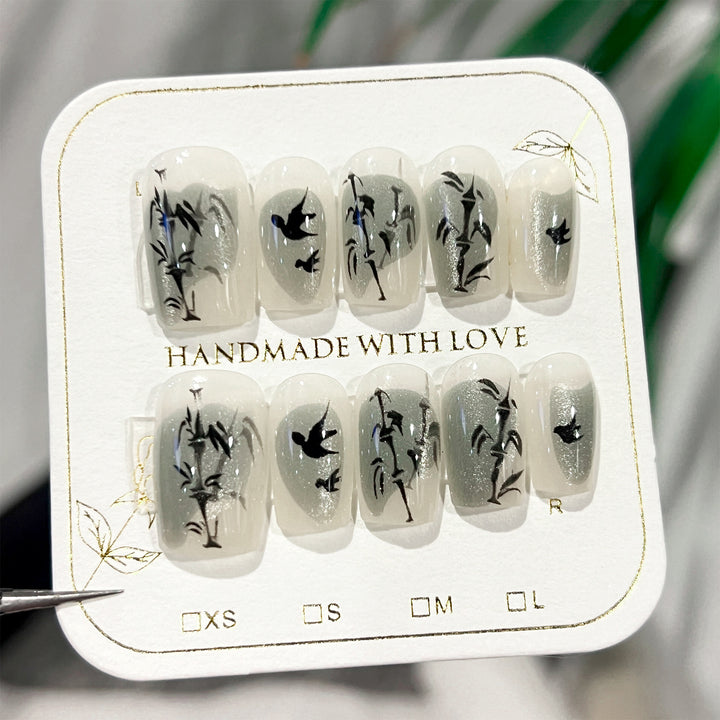 Handcrafted acrylic nails with decorative bird motifs Bowlift
