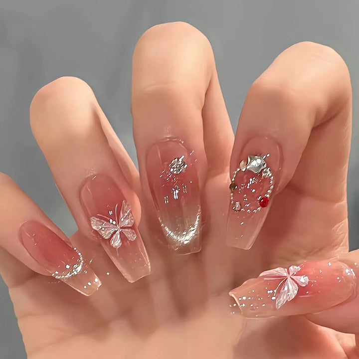 Artificial nail extensions with floral design and sparkling accents Bowlift