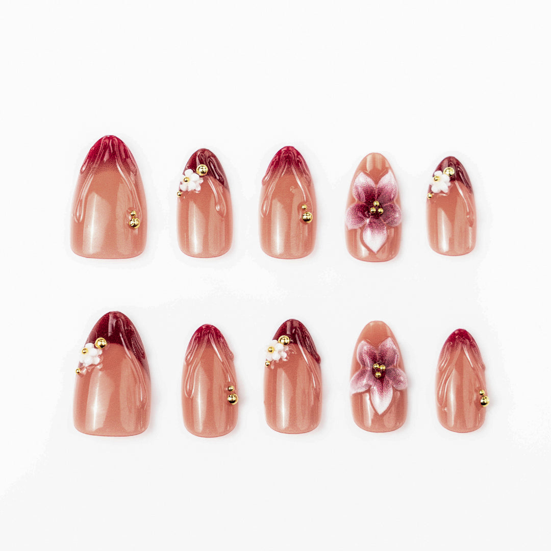 Artificial nail set with floral accents and gold embellishments Bowlift