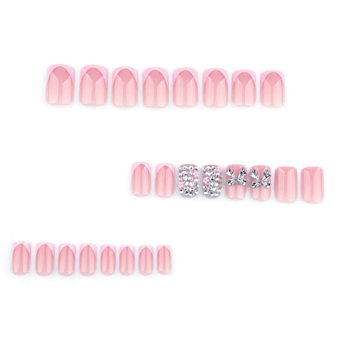 Artful nail art with glitter accents and bow decoration Bowlift