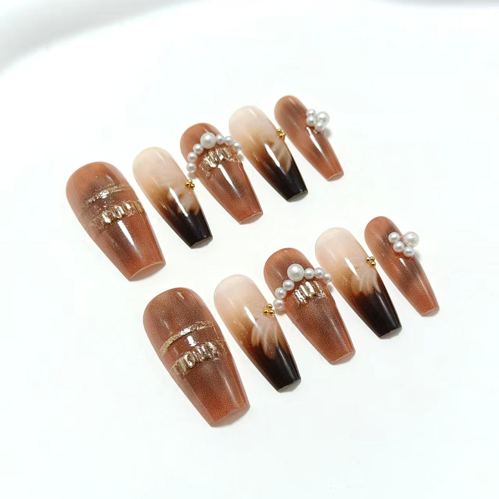 Artificial nails with glamorous gold and pearl embellished accents Bowlift