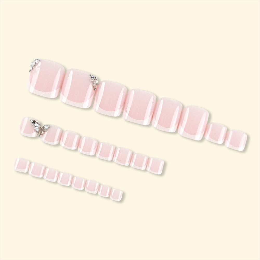 Artificial nail set with elegant French manicure and glitter accents Bowlift