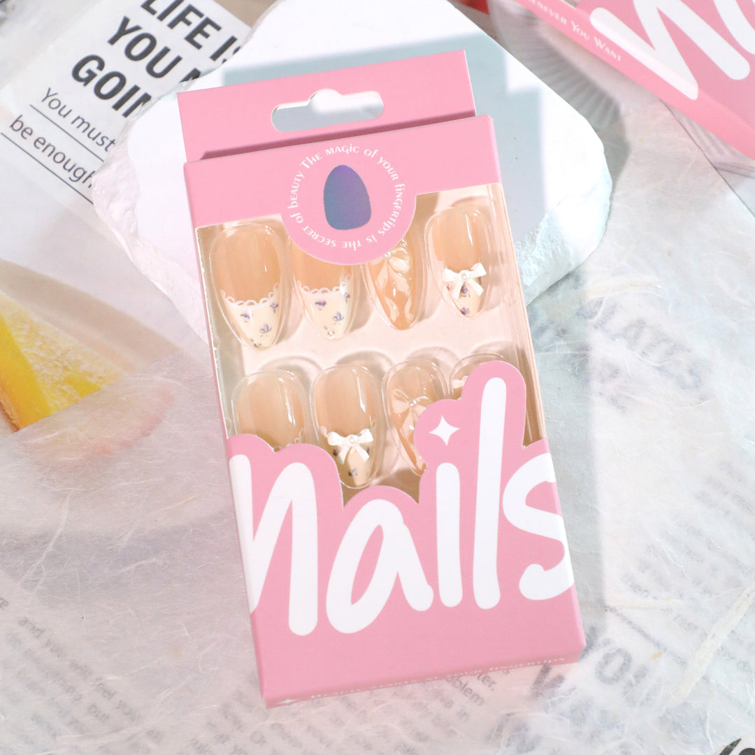 Artful nail art with elegant bows and rhinestone details Bowlift