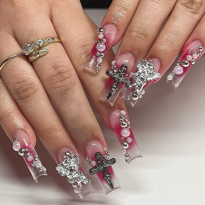 Glamorous artificial nail set with sparkling rhinestones and cross decorations Bowlift