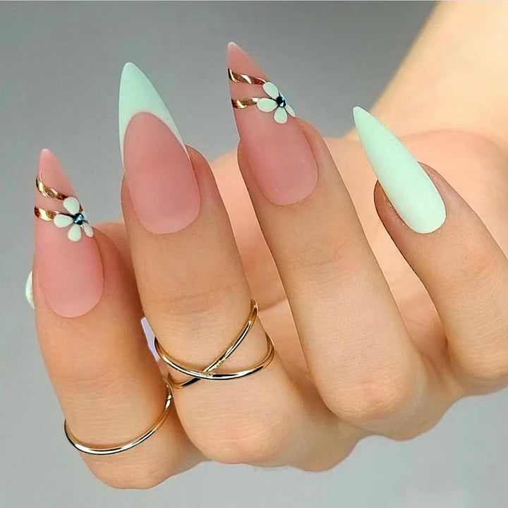 Artistic stiletto nails with floral accents and glitter embellishments Bowlift
