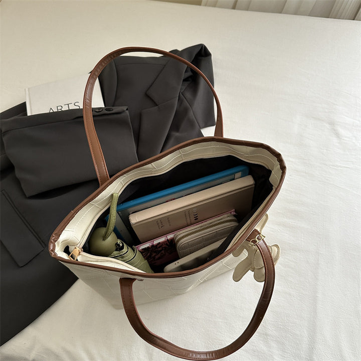 Stylish Textured Tote Bag with Decorative Charm