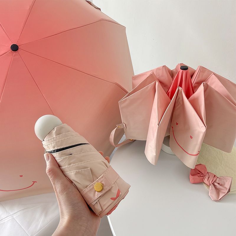 Women's foldable umbrella with playful design and handy wooden handle Bowlift