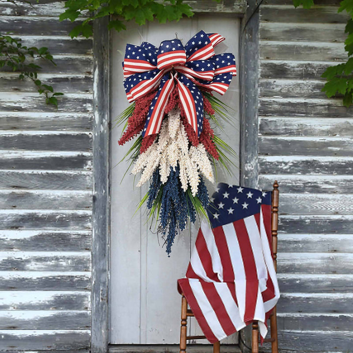 Unisex hanging floral swag with large bow and artificial berry branches Bowlift
