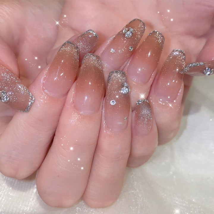 Glamorous artificial nails with glitter and rhinestone accents Bowlift