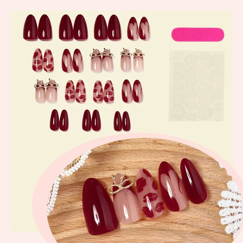 Acrylic nail set with elegant lip motifs and bow decorations Bowlift
