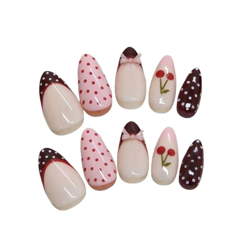 Artfully designed nail tips with cherry and dot motifs Bowlift