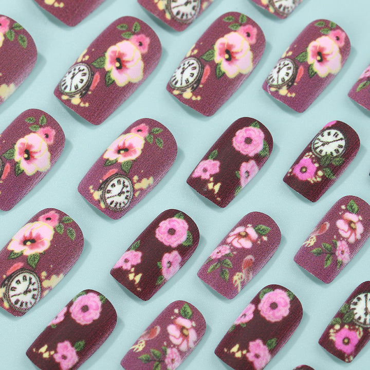 Nail art with floral design and intricate clock motifs Bowlift