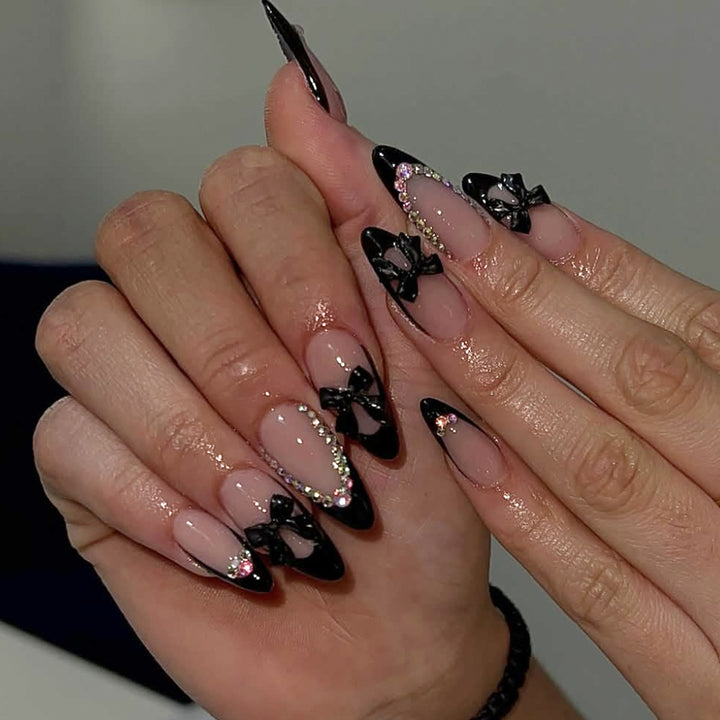 Elegant Stiletto Nail Design with Rhinestone Accents Bowlift