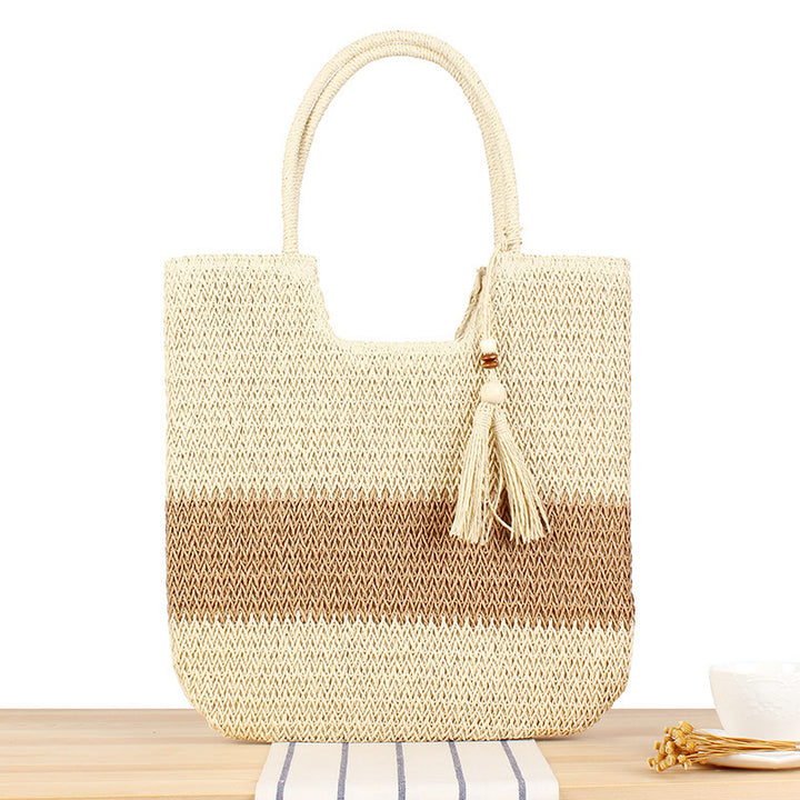 Fashionable beach tote bag made of woven natural material with fringed detail Bowlift