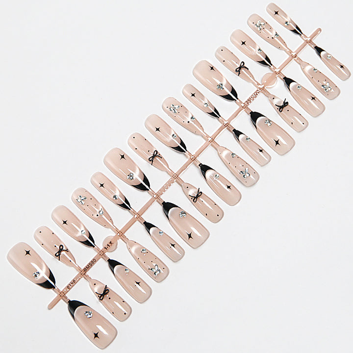 Nail art set with elegant black and white design and sparkling applications Bowlift