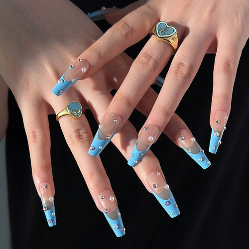 Artificial nail extensions with glitter and pearl accents Bowlift