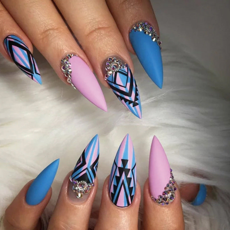 Artful stiletto nails with modern geometric designs and rhinestone embellishments Bowlift