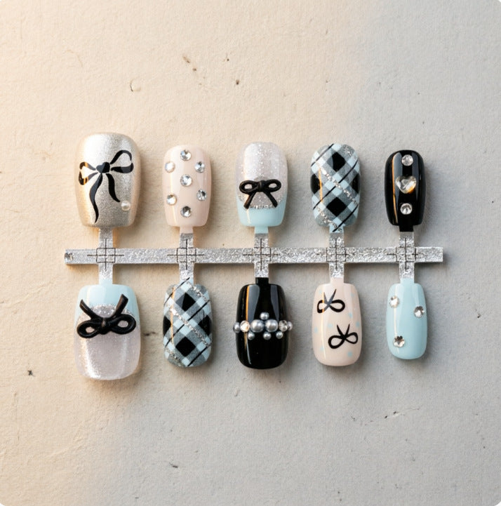 Artificial nails with elegant bows and rhinestones Bowlift