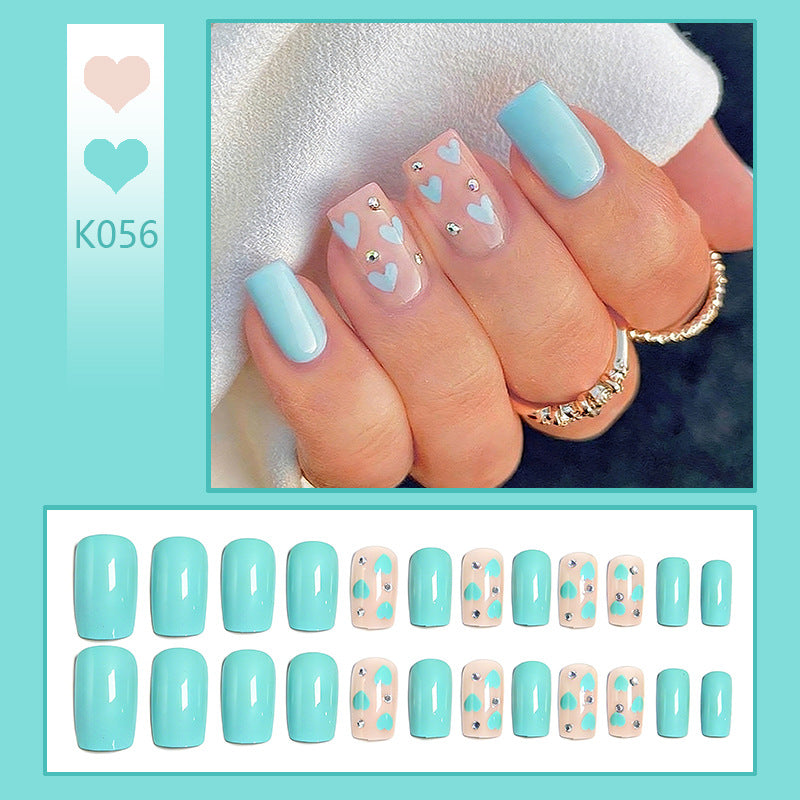Nail art with heart designs and glitter accents Bowlift