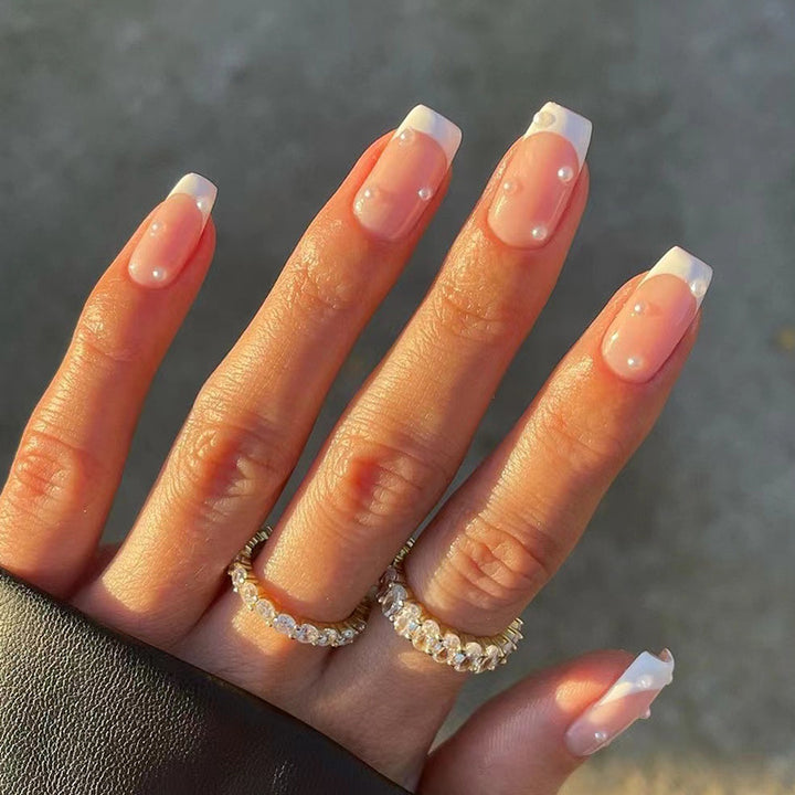 Artful nail art with elegant pearl and glitter accents Bowlift