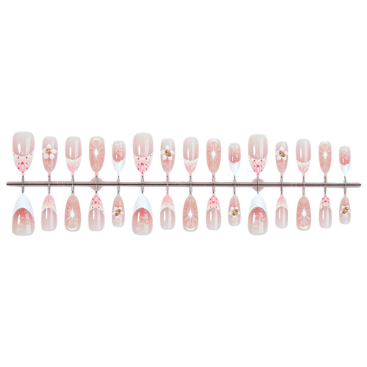 Creative acrylic nail set with floral accents and glitter decorations Bowlift