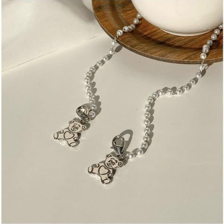Playful pearl necklace with gold pendants Bowlift