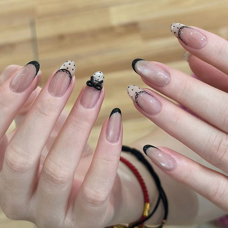 Artistic French Tip Nail Design with Bow Embellishments Bowlift