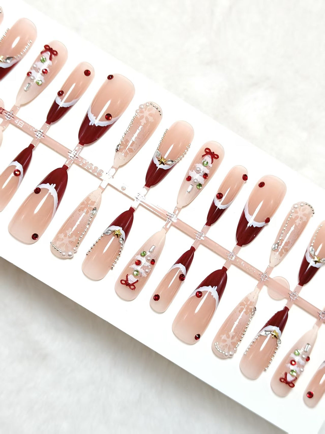 Artificial nails with festive designs and glitter accents Bowlift