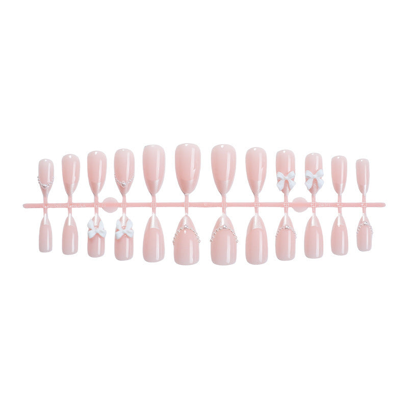 Artificial nail set with elegant bows and pearl embellishments Bowlift