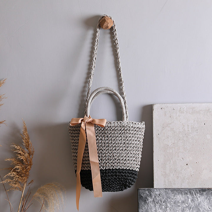 Basket bag with stylish carrying handles and decorative bow Bowlift