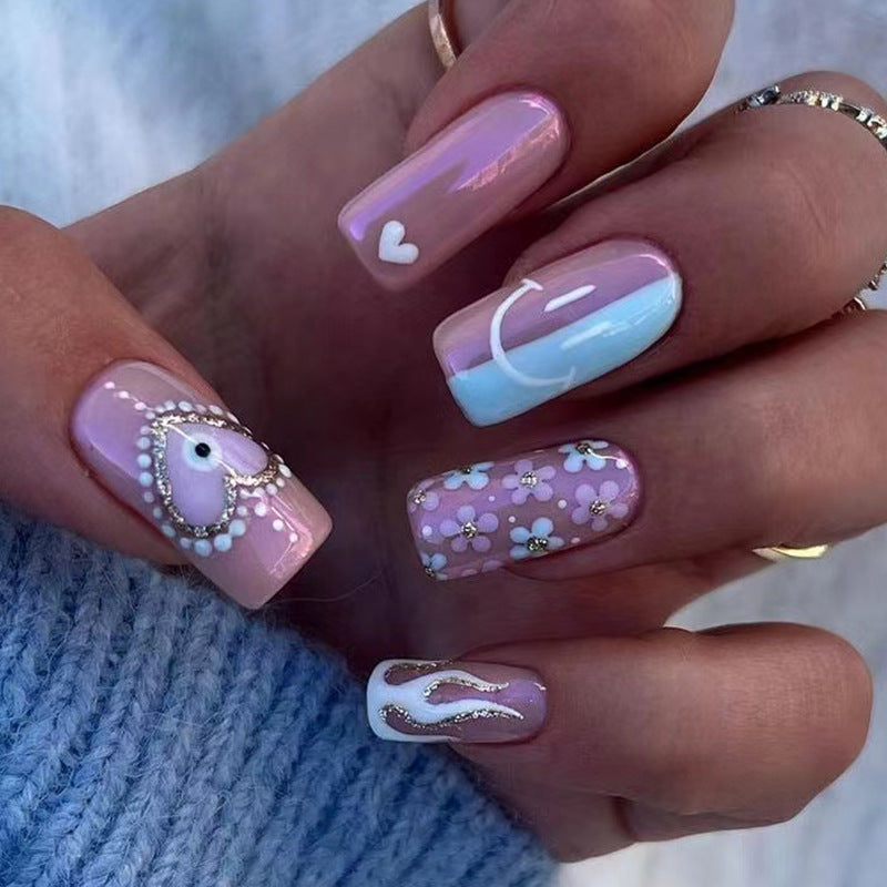 Artful nail art with floral accents and glitter embellishments Bowlift