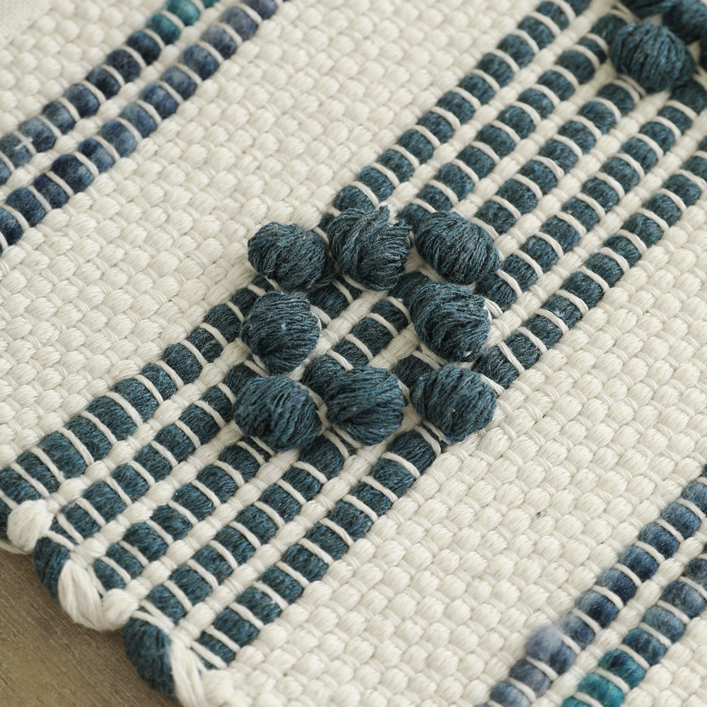 Woven cotton table runner with textured tufting and fringed border