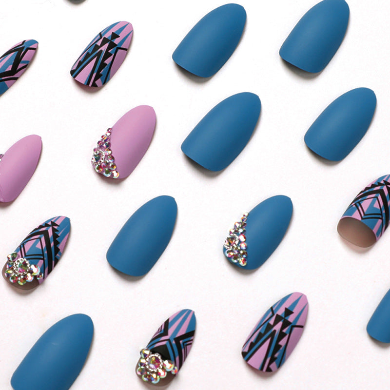 Artful stiletto nails with modern geometric designs and rhinestone embellishments Bowlift