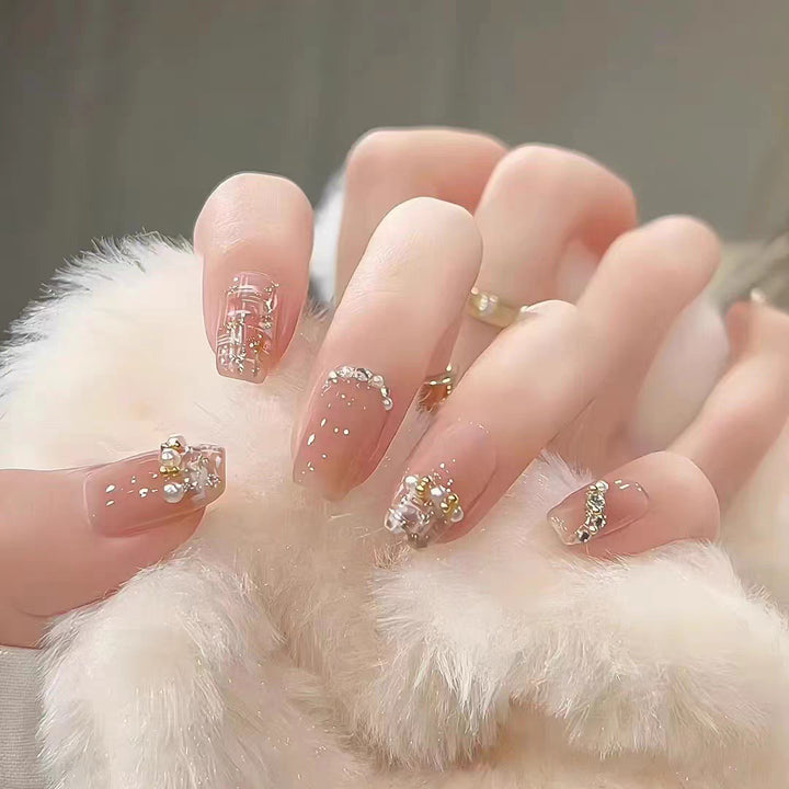 Artificial nails with elegant pearl and glitter decorations Bowlift