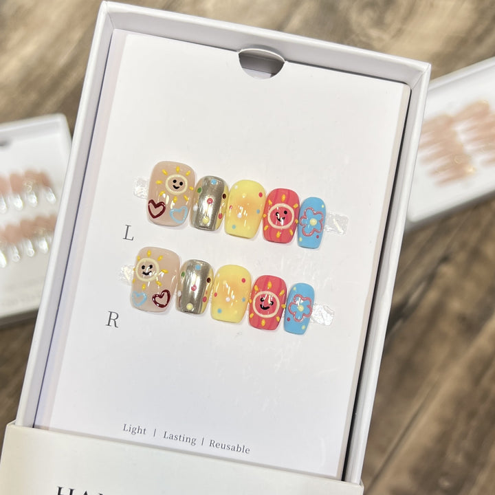 Whimsical Press-On Nail Art Set with Smiley Faces and Floral Designs Bowlift