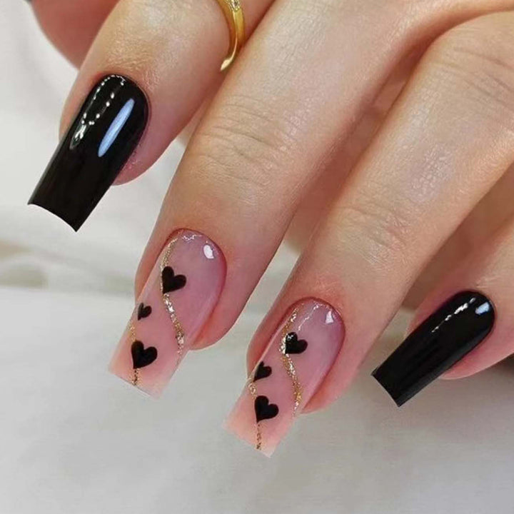 Artistic acrylic nails with heart design and glitter accents Bowlift