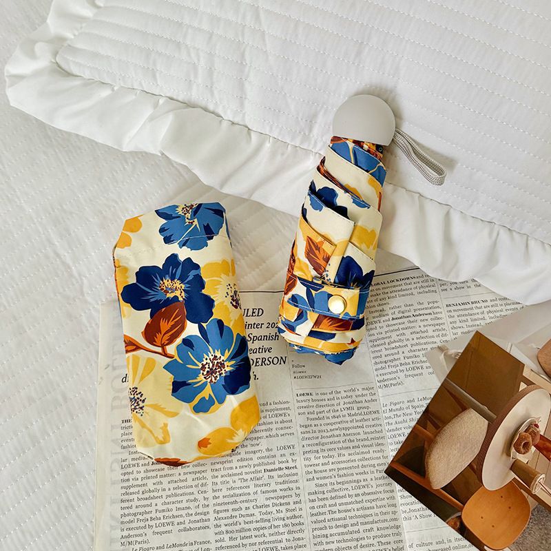 Women Folding Umbrella with Detailed Floral Design Bowlift